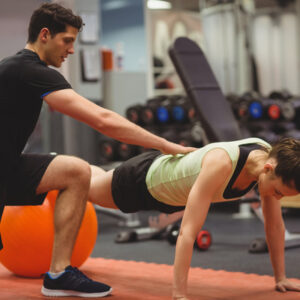 Personal trainer helping out client